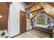 Cozy bedroom with vaulted ceilings, wood beams, and a large arched window at 506 Burgess Rd, Apex, NC 27523