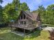 Side view of the home with large deck and stone facade at 506 Burgess Rd, Apex, NC 27523