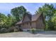 The side of the house features a large deck, yard and gravel driveway at 506 Burgess Rd, Apex, NC 27523