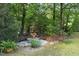 Secluded garden area with stone benches and lush greenery, perfect for relaxation at 506 Burgess Rd, Apex, NC 27523