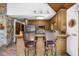 Kitchen features wood cabinets, a stainless steel refrigerator, breakfast bar, and a wood ceiling at 506 Burgess Rd, Apex, NC 27523