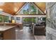 Bright living room boasts wood ceilings, large windows, a dining area, and access to the outdoor space at 506 Burgess Rd, Apex, NC 27523