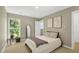 Cozy bedroom with natural light, neutral decor, and comfortable furnishings, creating a relaxing atmosphere at 506 N Mangum St # 402, Durham, NC 27701