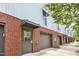 Close up of the exterior of a brick townhome featuring garages and modern industrial design at 506 N Mangum St # 402, Durham, NC 27701