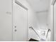 Hallway with two doors on each side, a wooden handrail and stairs leading down with some visible light at 506 N Mangum St # 402, Durham, NC 27701
