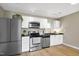 Modern kitchen with stainless steel appliances, white cabinets, and ample counter space at 506 N Mangum St # 402, Durham, NC 27701