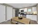 Well-lit kitchen boasts stainless steel appliances, white cabinetry, and a dining space at 506 N Mangum St # 402, Durham, NC 27701