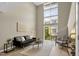 Bright living room featuring soaring ceilings and a wall of windows for natural light and views at 506 N Mangum St # 402, Durham, NC 27701