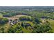 Stunning aerial view of a large estate, featuring a picturesque home with a pond, mature trees, and scenic landscape at 5250 Sartin Rd, Burlington, NC 27217