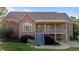 Brick home with an open deck and outdoor living space for relaxing and entertaining guests at 5250 Sartin Rd, Burlington, NC 27217