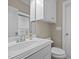 Bright bathroom featuring a white vanity, toilet, and shower with sleek fixtures and neutral-toned walls at 5250 Sartin Rd, Burlington, NC 27217