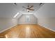 Spacious bonus room with hardwood floors, a skylight, a ceiling fan, and a window offering natural light at 5250 Sartin Rd, Burlington, NC 27217