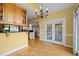 A dining room next to the kitchen with access to the outdoor deck through a set of glass paneled double doors at 5250 Sartin Rd, Burlington, NC 27217
