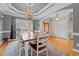 Elegant dining area featuring a modern chandelier, large window, and a wooden dining table at 5250 Sartin Rd, Burlington, NC 27217