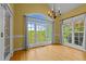 A dining room that boasts large windows, letting in plenty of natural light, and beautiful hardwood floors at 5250 Sartin Rd, Burlington, NC 27217