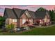 Charming brick home with lush landscaping and a beautiful front yard is perfect for families or empty-nesters at 5250 Sartin Rd, Burlington, NC 27217