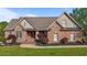 Beautiful brick home with manicured lawn and landscaped flower beds, exuding curb appeal at 5250 Sartin Rd, Burlington, NC 27217