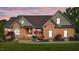Stunning brick home featuring well-maintained landscaping and a charming covered entrance at 5250 Sartin Rd, Burlington, NC 27217