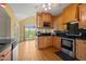 Bright kitchen featuring custom wood cabinetry, sleek appliances, and natural light at 5250 Sartin Rd, Burlington, NC 27217