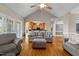 Open-concept living room with hardwood floors, a vaulted ceiling, and a seamless flow to the kitchen at 5250 Sartin Rd, Burlington, NC 27217
