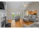 Cozy living room with a fireplace, comfortable seating, and large windows for natural light at 5250 Sartin Rd, Burlington, NC 27217