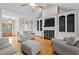 Spacious living room with a fireplace, built-in shelving, and comfortable sofas at 5250 Sartin Rd, Burlington, NC 27217