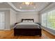Spacious main bedroom features hardwood floors, tray ceilings, and a large window overlooking the yard at 5250 Sartin Rd, Burlington, NC 27217