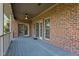 Inviting outdoor patio with brick construction, ceiling fans, recessed lighting, and sliding glass doors at 5250 Sartin Rd, Burlington, NC 27217