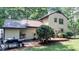 Exterior rear view of a tan home featuring an elevated deck with a porch swing at 5728 Carriagehouse Ct, Apex, NC 27539