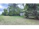 Spacious backyard featuring green grass and bordered by mature trees at 5728 Carriagehouse Ct, Apex, NC 27539