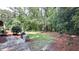 Beautiful backyard featuring mature trees and a custom grill area at 5728 Carriagehouse Ct, Apex, NC 27539