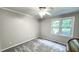 Bright bedroom with a ceiling fan, lush carpet, and large window at 5728 Carriagehouse Ct, Apex, NC 27539
