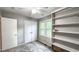 Neutral bedroom featuring plush carpet, built in shelving, and natural light at 5728 Carriagehouse Ct, Apex, NC 27539