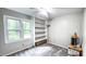 Bright bedroom with plush carpet, large window, and built-in shelving at 5728 Carriagehouse Ct, Apex, NC 27539