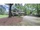 A view of the home showing the long driveway with large trees offering shade and privacy at 5728 Carriagehouse Ct, Apex, NC 27539