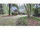 A charming two-story home with mature trees, lush landscaping and a long, inviting driveway at 5728 Carriagehouse Ct, Apex, NC 27539