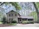 Charming two-story home with red shutters and a landscaped front yard, enveloped by tall trees at 5728 Carriagehouse Ct, Apex, NC 27539