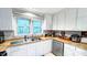 Bright kitchen featuring white cabinets, butcher block countertops, stainless steel appliances, and a window with a view at 5728 Carriagehouse Ct, Apex, NC 27539
