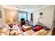Cozy living room with leather seating, a mounted TV, and natural light from a window at 5728 Carriagehouse Ct, Apex, NC 27539