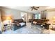 Bright living room featuring neutral decor, ceiling fan and comfortable furnishings at 5728 Carriagehouse Ct, Apex, NC 27539