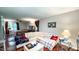 Open concept living room connected to bedroom, with hardwood floors, ceiling fan, and sectional couch at 5728 Carriagehouse Ct, Apex, NC 27539