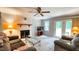 Cozy living room with a ceiling fan and a sliding glass door that leads to the outside at 5728 Carriagehouse Ct, Apex, NC 27539