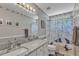Bathroom features a patterned shower curtain, patterned mirror trim, and granite countertop at 5909 Royal Coach Ct, Raleigh, NC 27612