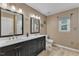 Bathroom featuring double sink vanity, neutral walls, and framed mirrors at 5909 Royal Coach Ct, Raleigh, NC 27612