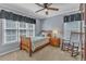 Bedroom showcasing a bed with two windows and a rocking chair at 5909 Royal Coach Ct, Raleigh, NC 27612