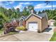 Side view of a cozy single-Gathering home with an attached garage and a well-manicured lawn at 5909 Royal Coach Ct, Raleigh, NC 27612