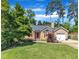 Inviting home with a green lawn, tidy landscaping, and a charming entrance with red door and shutters at 5909 Royal Coach Ct, Raleigh, NC 27612