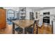 Open kitchen and dining area features updated stainless appliances and hardwood floors at 5909 Royal Coach Ct, Raleigh, NC 27612