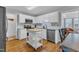 Bright kitchen with white cabinetry, a stainless-steel appliances, and a marble backsplash at 5909 Royal Coach Ct, Raleigh, NC 27612