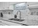 Close up of the kitchen granite countertops and white backsplash at 5909 Royal Coach Ct, Raleigh, NC 27612
